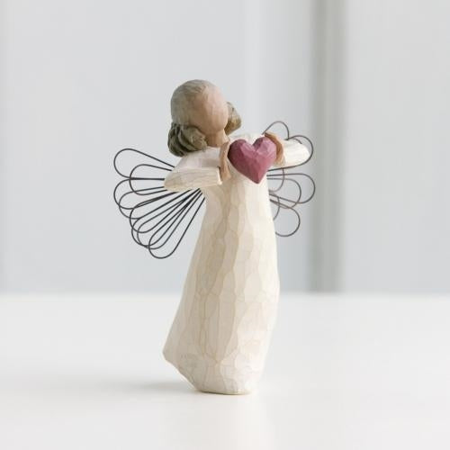With Love Angel figurine holding a red heart as a heartfelt love gift